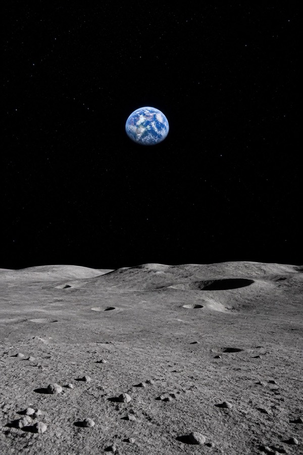 Earth rising above a grey lunar horizon